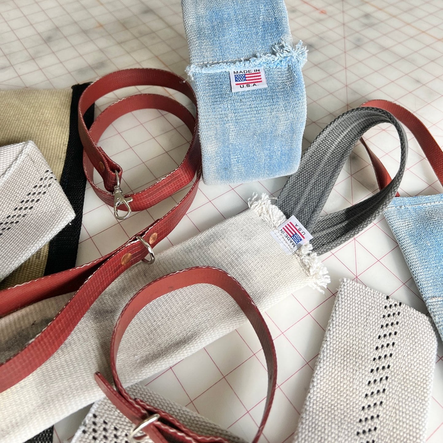 Close-up view of multiple Fire Hose Dog Tug Toys showing the reinforced stitching, hose material, and red loop handles.