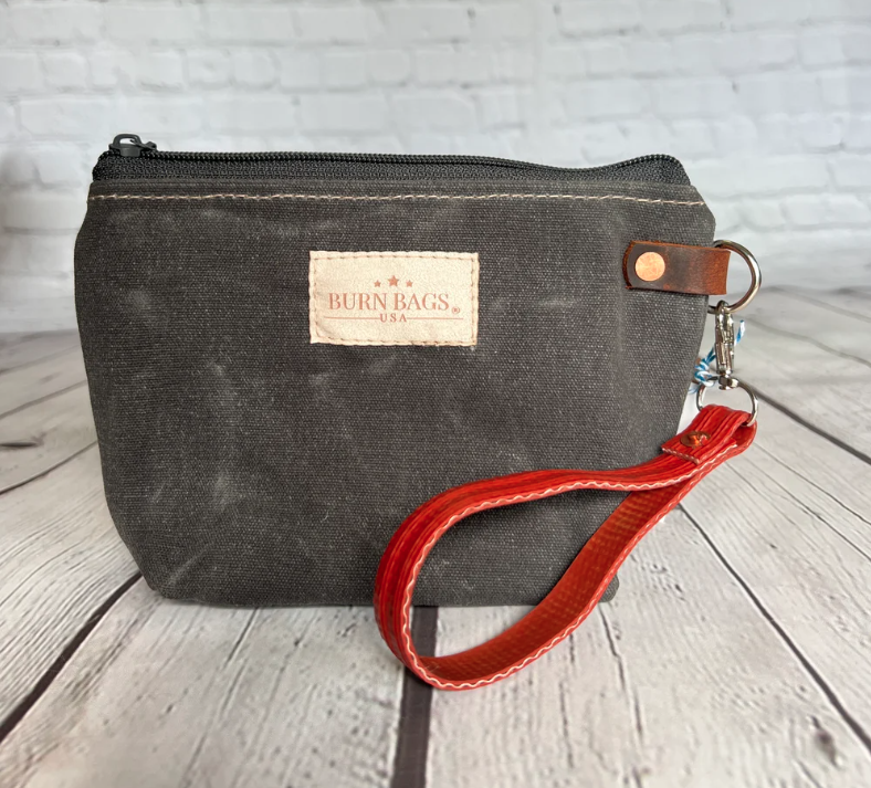 Charcoal waxed canvas Rubber Fire Hose Clutch with detachable red fire-hose wristlet.