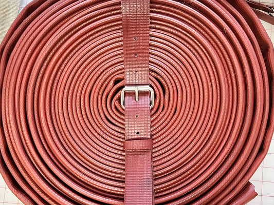 Close-up of the Red Rubber Fire Hose Belt showing detailed hose texture and stitching.