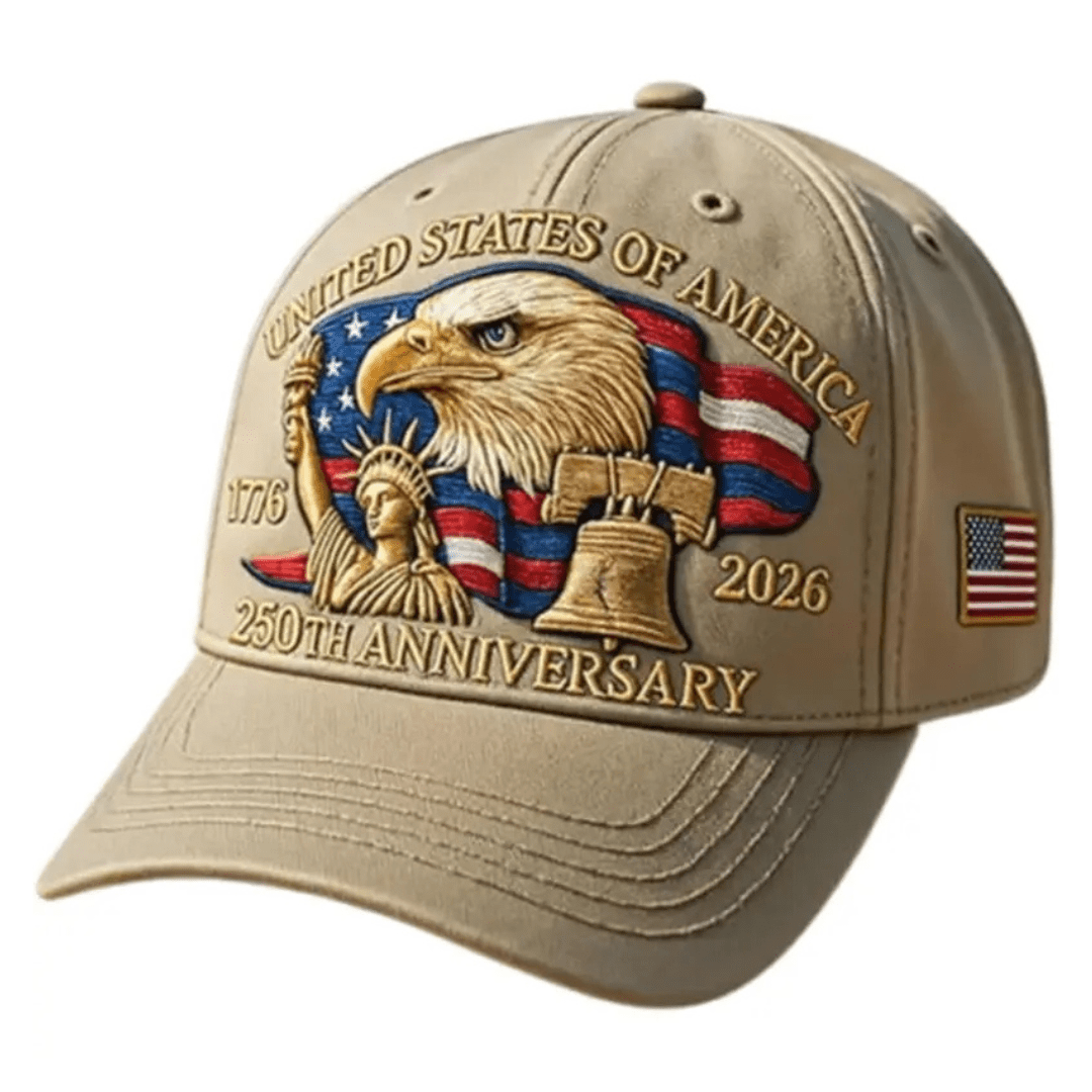 Beige cap with American-themed design featuring an eagle, Statue of Liberty, and Liberty Bell on a white background.