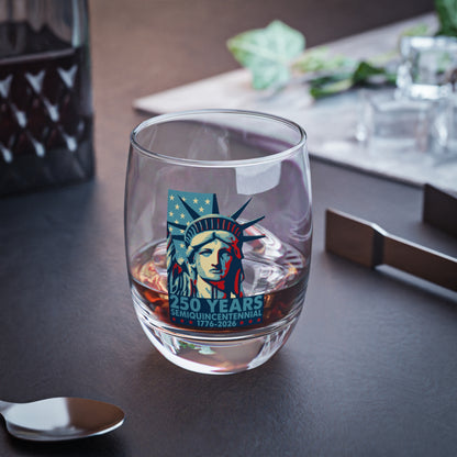 Clear glass with a design of the Statue of Liberty on a dark surface