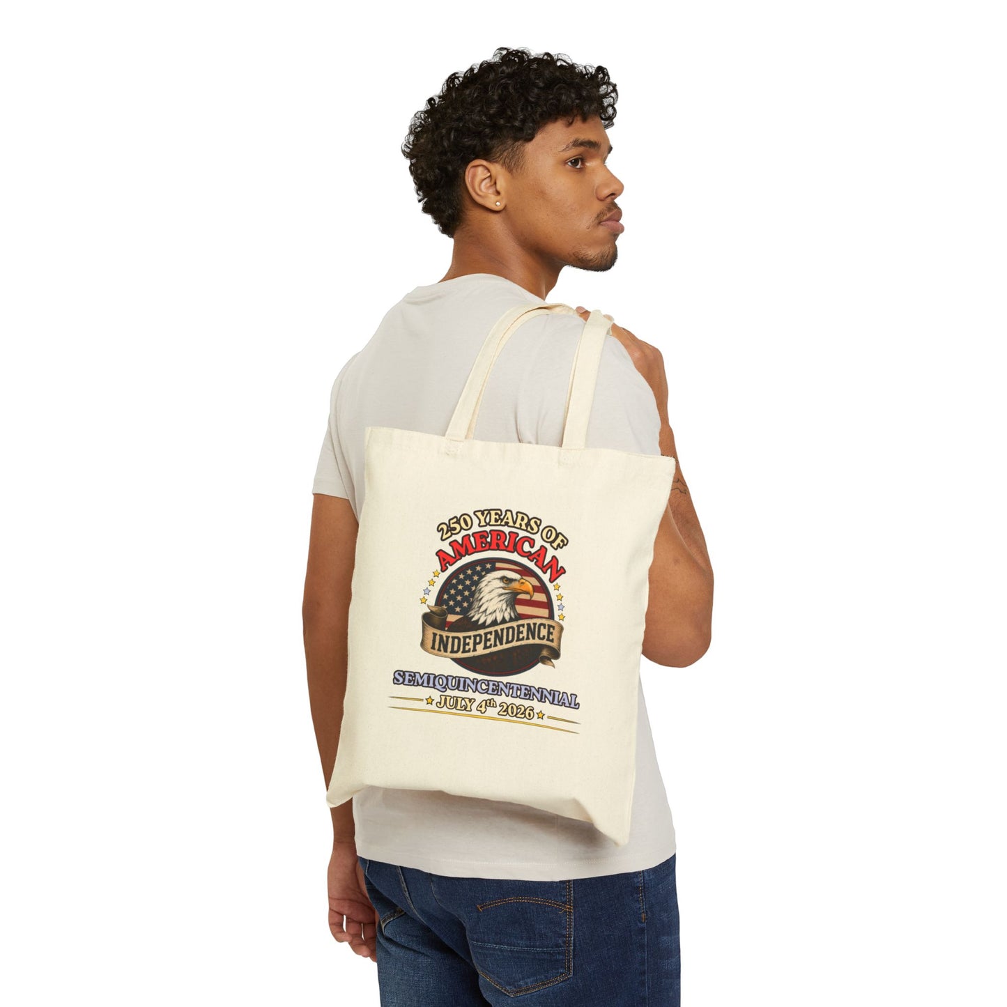 Man carrying an America 250 independence eagle canvas tote bag in natural cotton, vintage Americana print, 15x16