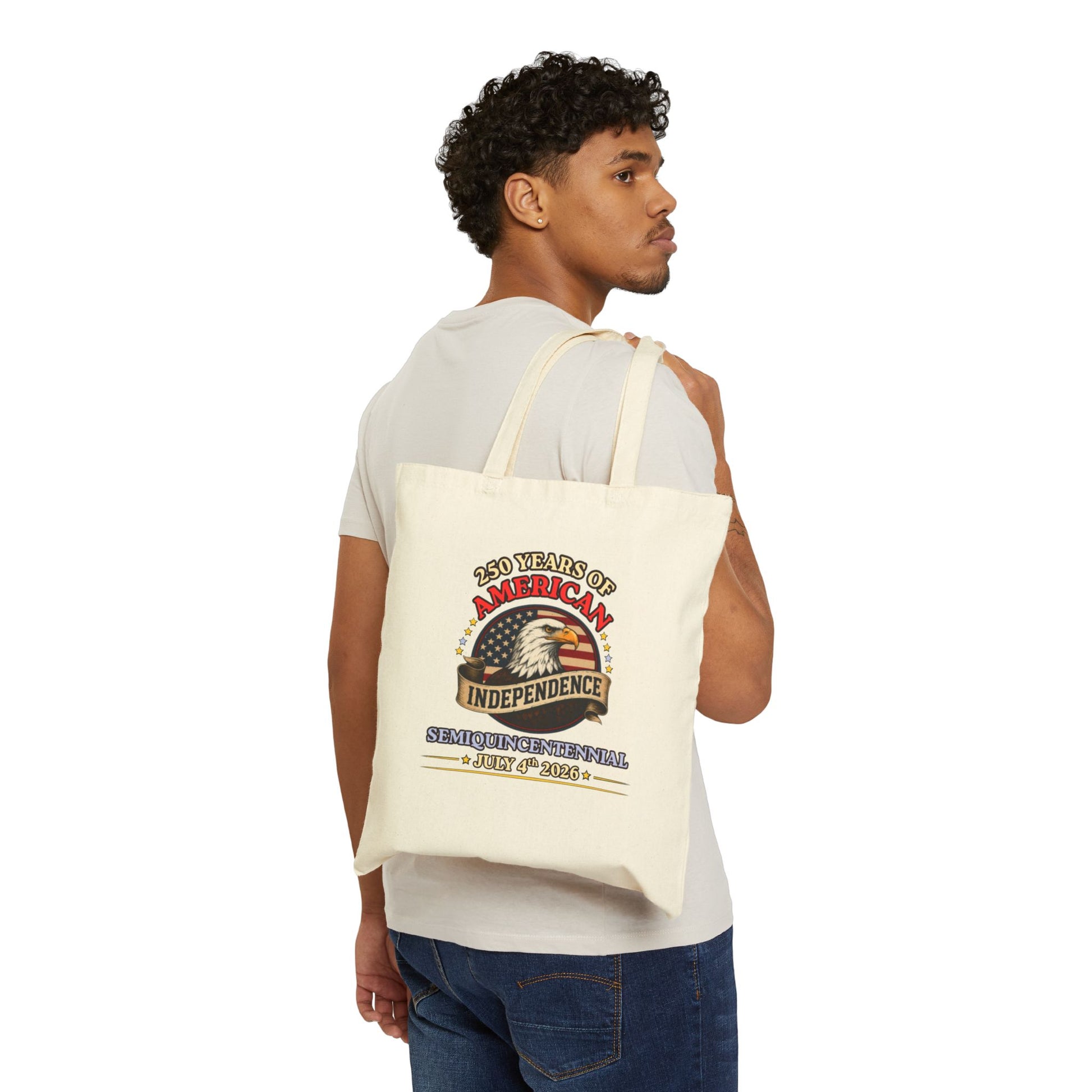 Man carrying an America 250 independence eagle canvas tote bag in natural cotton, vintage Americana print, 15x16