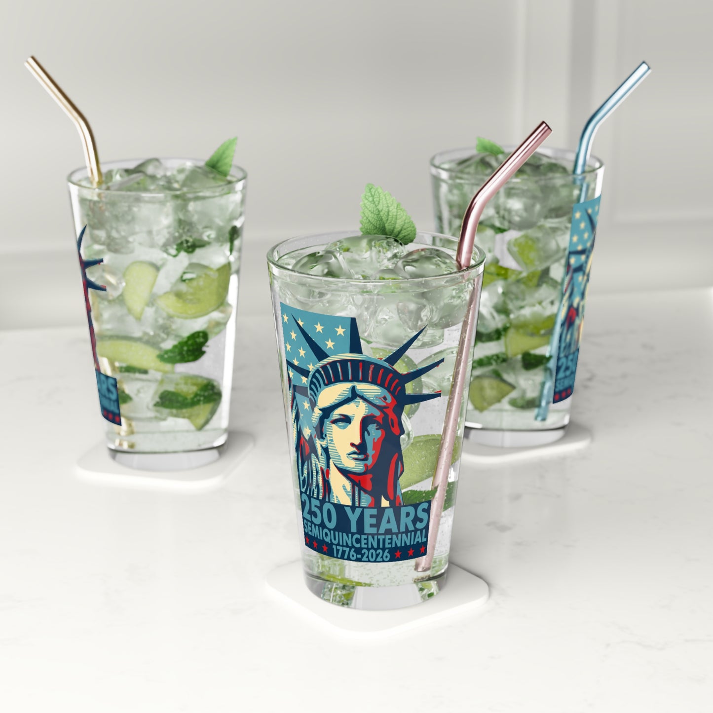 Three glasses of iced beverages with straws on a white background, featuring a design of the Statue of Liberty.