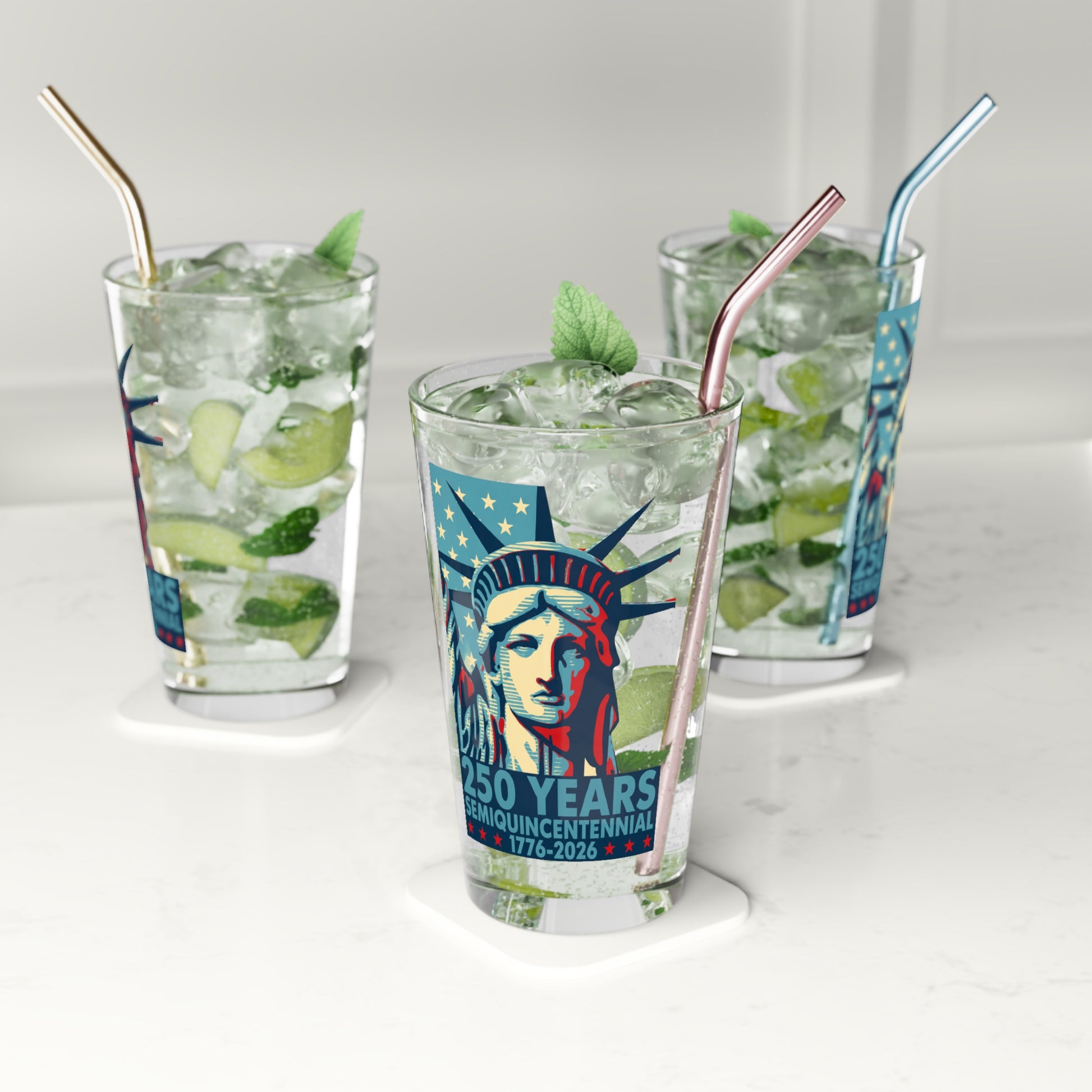 Three glasses of iced beverages with straws on a white background, featuring a design of the Statue of Liberty.