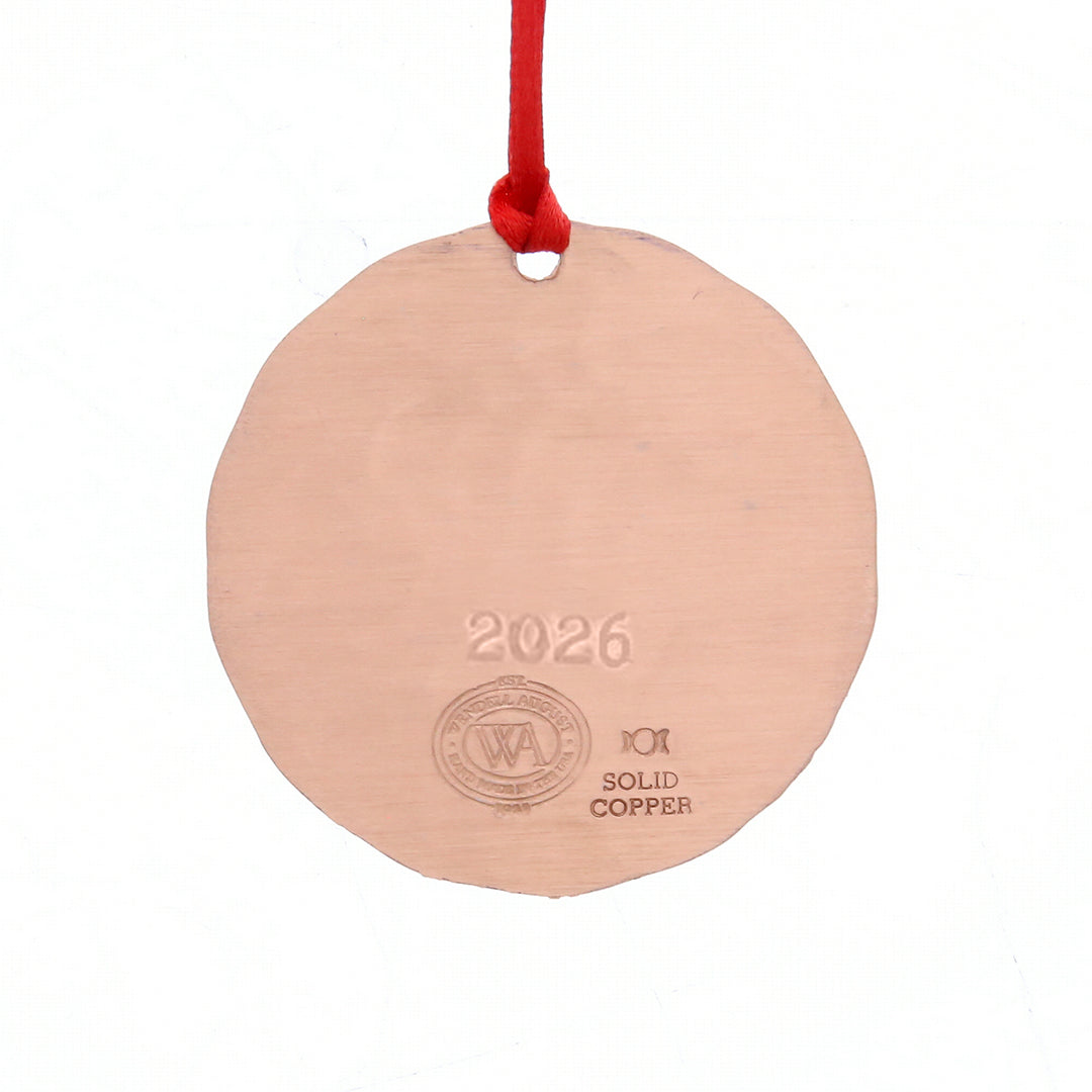 Back of Wendell August Forge Round solid copper ornament with '2026' engraving and red string on a white background