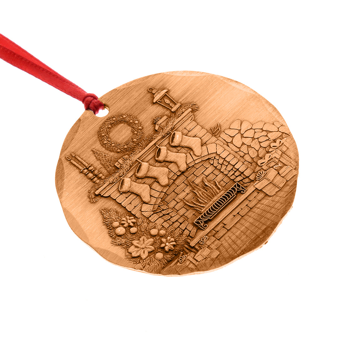 Bronze ornament with intricate designs on a white background