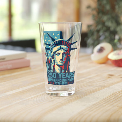 Glass with Statue of Liberty design and '250 Years' text on a wooden table