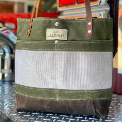 Olive Green Classic Burn Bag made from decommissioned fire hose and waxed canvas with double leather straps and front hose panel.