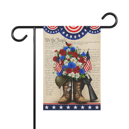 Decorative flag with American flags, flowers, boots, and a rifle on a white background.