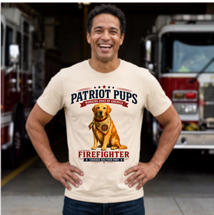 Man wearing a 'Patriot Pups' t-shirt with a dog graphic in front of fire trucks.