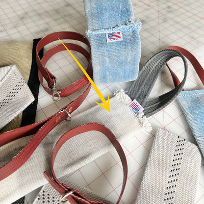 Group of Fire Hose Dog Tug Toys made from decommissioned hose, shown on a grid-patterned worktable with red and black loop handles.