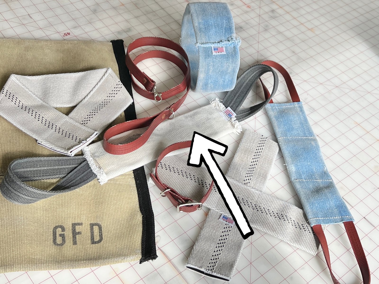 Dog tug toy made from decommissioned fire hose with reinforced stitching and visible hose texture.