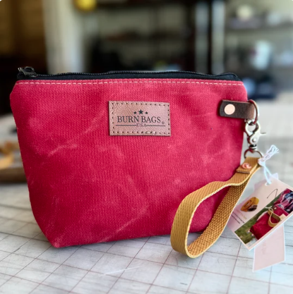 Fire Engine Red waxed canvas Rubber Fire Hose Clutch with detachable red fire-hose wristlet.