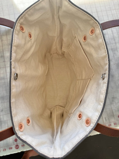 Interior view of Peony Pink Classic Burn Bag showing full lining, dual inside pockets, and snap closure.