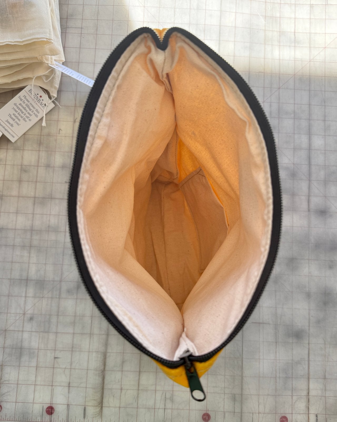 Interior view of Olive Green Crossbody Burn Bag showing full lining and zipper opening.