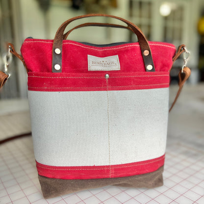 Engine Red Engineer Burn Bag made from waxed canvas and decommissioned fire hose with leather handles and detachable strap.