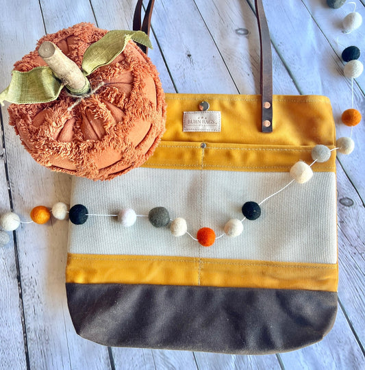 Mustard Yellow Classic Burn Bag made from decommissioned fire hose with double 28-inch leather straps and front hose panel.