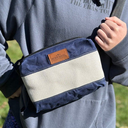 Navy Fanny Pack made from waxed canvas and decommissioned fire hose with adjustable strap.