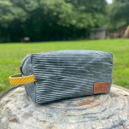 Hickory Striped Pouch made from durable striped fabric with reinforced bottom and zipper closure.