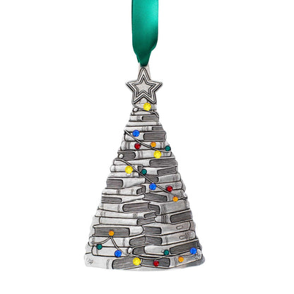 A silver Christmas tree ornament shaped like a stack of books, decorated with small multicolored lights and a green ribbon at the top, shown on a plain white background.