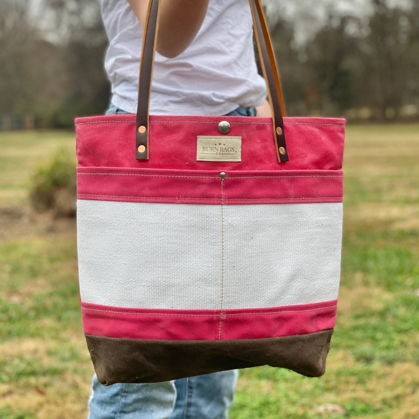 Peony Pink Classic Burn Bag made from decommissioned fire hose with 28-inch leather straps and a front hose panel.