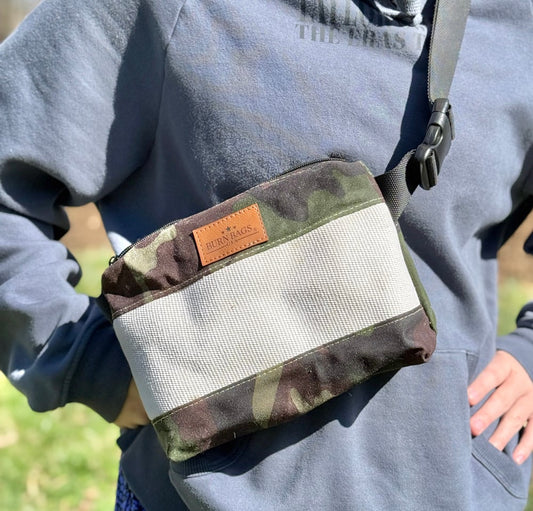 Person wearing crossbody the Special Edition Camo Fanny Pack made from reclaimed fire hose with the BurnBags label visible.