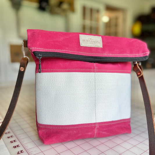 Peony Pink Crossbody Burn Bag made from decommissioned fire hose with fold-over design and a 48-inch leather strap.