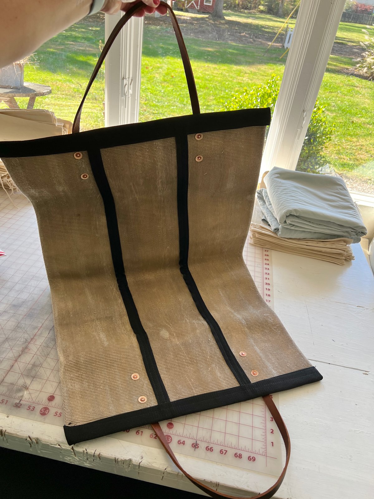 Angled view of the Fire Hose Wood Carrier showing width and handle construction.