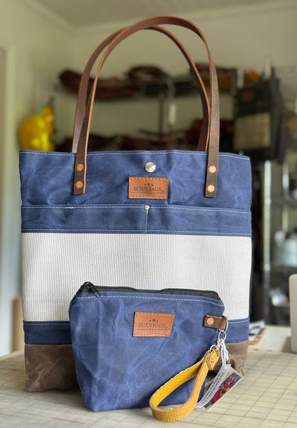 Navy Blue Classic Burn Bag paired with a matching navy pouch and yellow fire hose wristlet on a table.