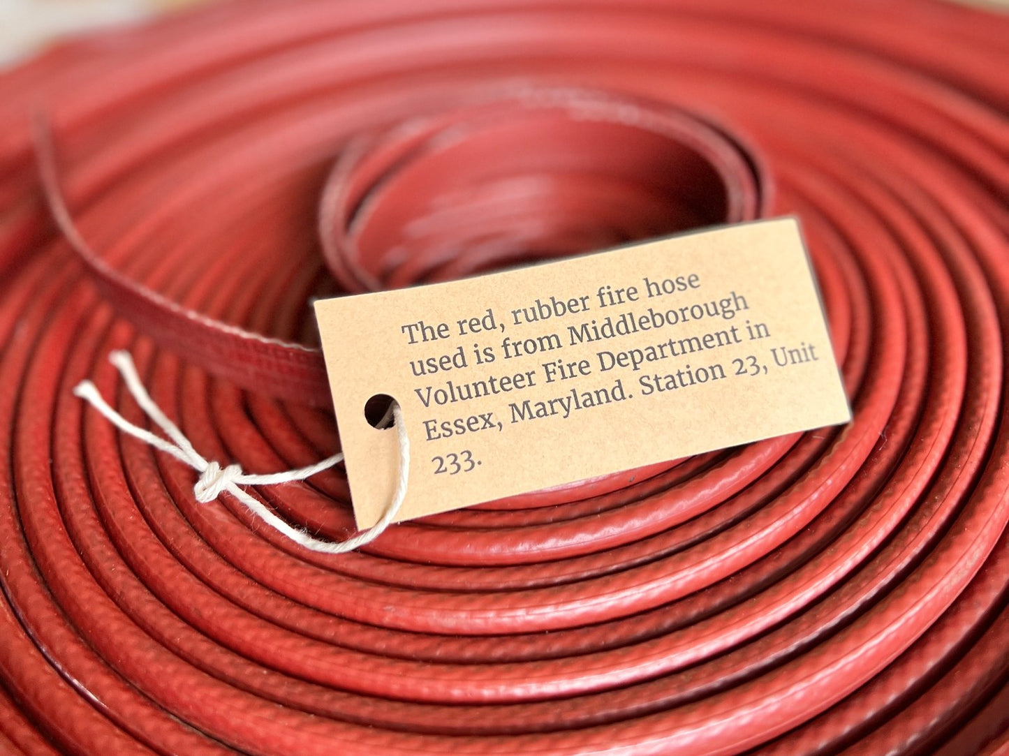 Authenticity card included with the Fire Hose Belt showing the hose’s fire department origin.
